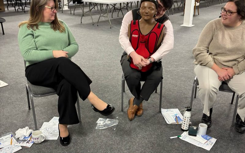 Trainer demonstrating infant CPR during an on-site emergency paediatric first aid course