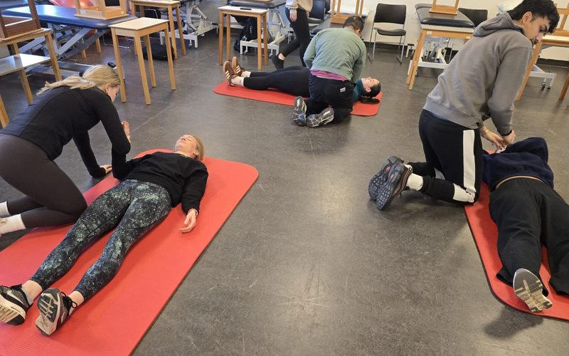 First aid refresher training in progress — delegate practising CPR during a half-day skills update