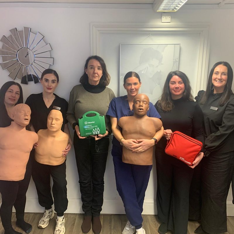 A group of colleagues holding their first aid certificates at the end of their training course
